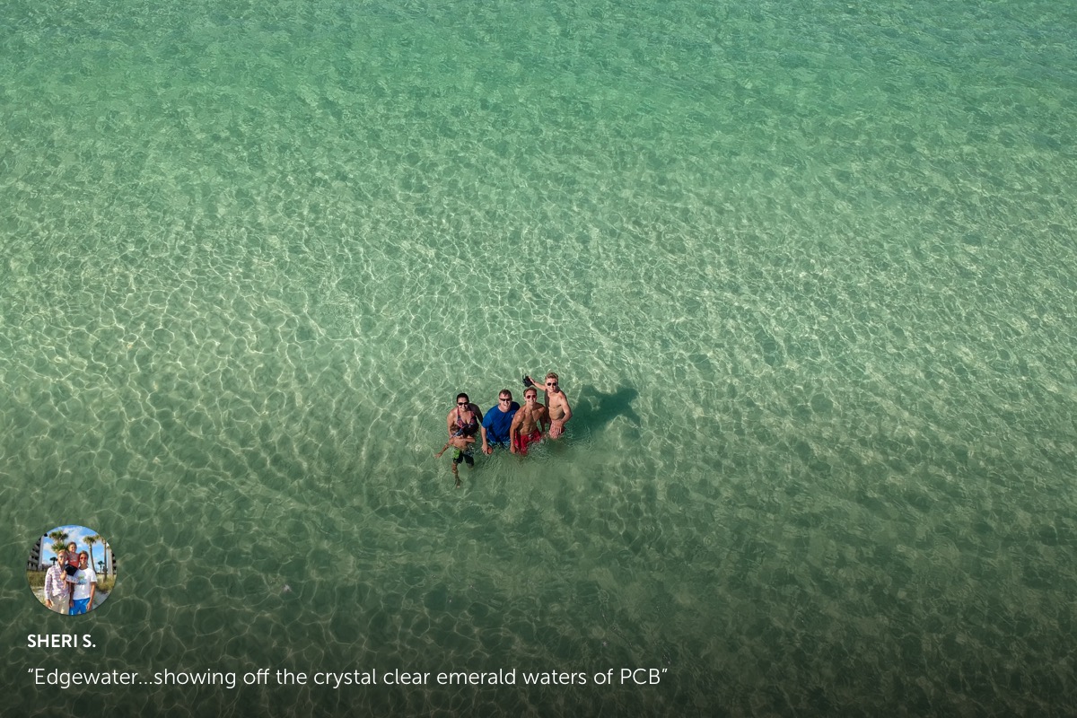 Photo submission from Sheri S. a family of 4 standing in the middle of crystal clear waters of a beach