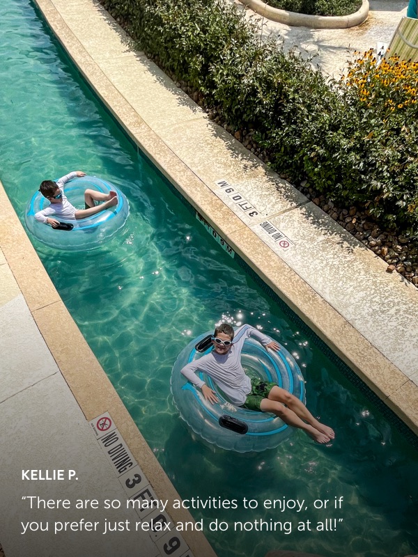 Photo submission from Kellie P. showing 2 boys on innertubes floating down a lazy river in a water park.