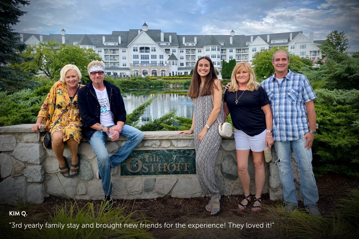 Photo submission from Kim Q., showing a The Osthoff Resort sign with a couple and a family of 3 standing on either side of the sign.